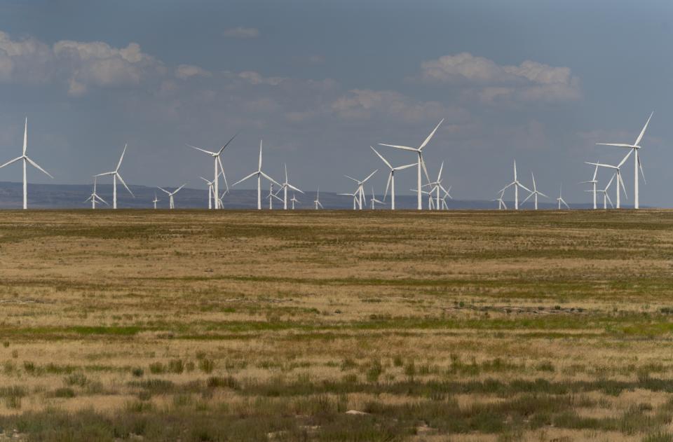 FILE - Wind turbines are seen from Interstate-84, July 9, 2023, near Hammett, Idaho. The federal Bureau of Land Management’s preferred alternative for a proposed large-scale wind energy farm in southern Idaho would shrink its size by nearly half and move it farther from a national historic site. (AP Photo/Lindsey Wasson, File)