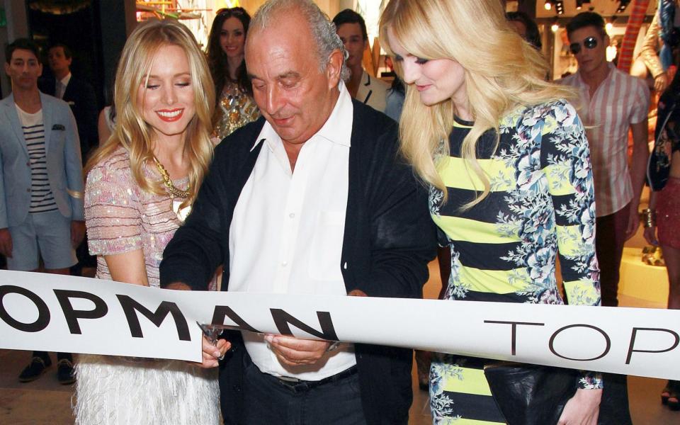 Sir Philip Green at the 2012 opening of a Topshop store in Las Vegas with actress Kristen Bell (left) and model Lydia Hearst (right)