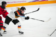 Germany's Parker Tuomie (62) clears the puck ahead of Canada's Cody Glass (8) during the gold medal match at the Ice Hockey World Championship in Tampere, Finland, Sunday, May 28, 2023. (AP Photo/Pavel Golovkin)
