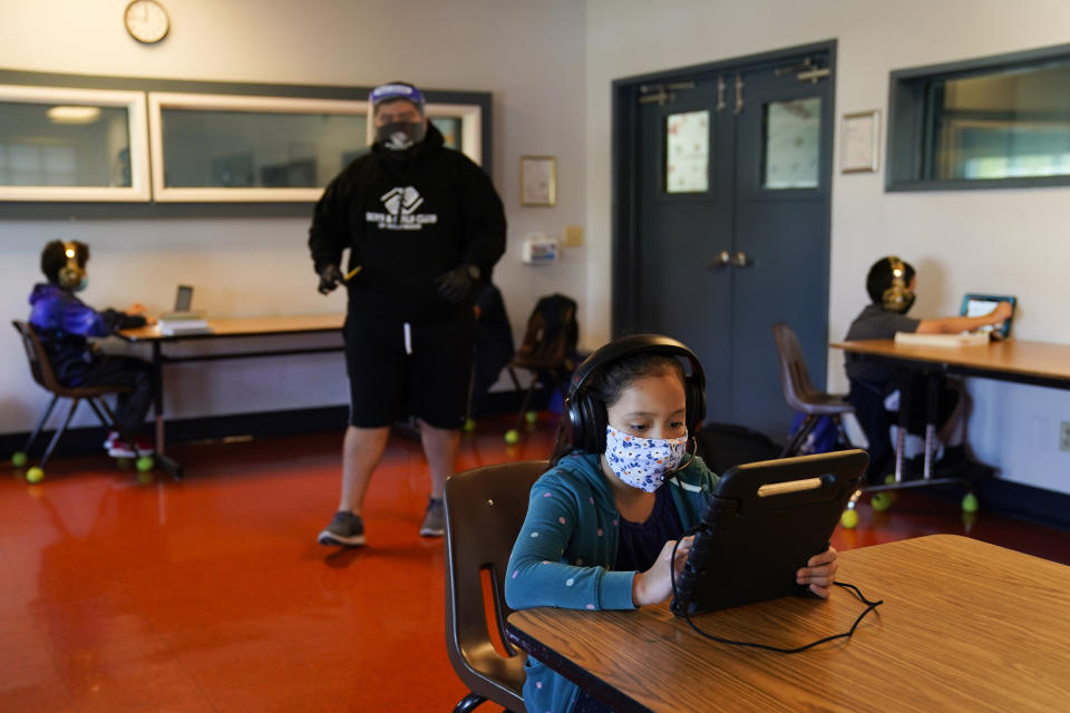 FILE - Los Angeles Unified School District students attend online classes at Boys & Girls Club of Hollywood in Los Angeles, Aug. 26, 2020. “It is very easy with hindsight to say, ‘Oh, learning loss, we should have opened.’ People forget how many people died,” said Austin Beutner, former superintendent in Los Angeles, where students were online until the start of hybrid instruction in April 2021. (AP Photo/Jae C. Hong, File)