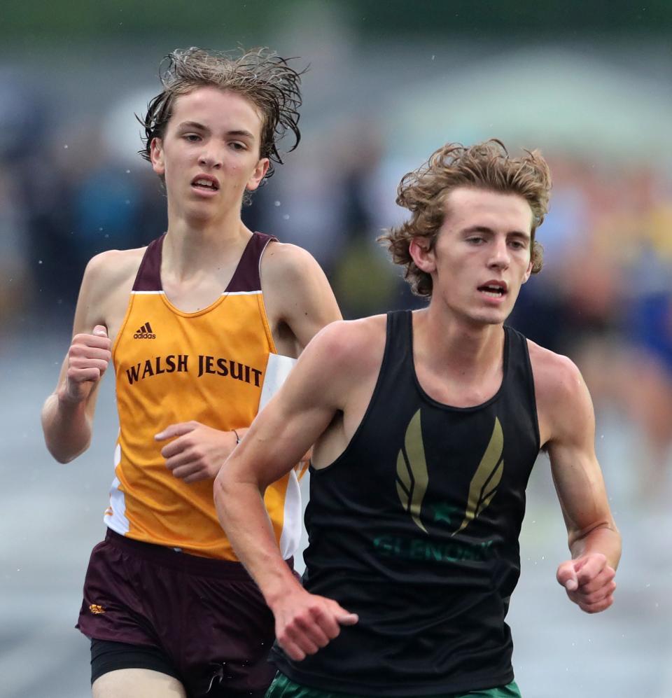 Walsh Jesuit's Luke Ondracek, left, passes GlenOak's Thomas Rice in the boys 3,200-meter run during the Division I regional track and field meet at Austintown Fitch High School on Friday.