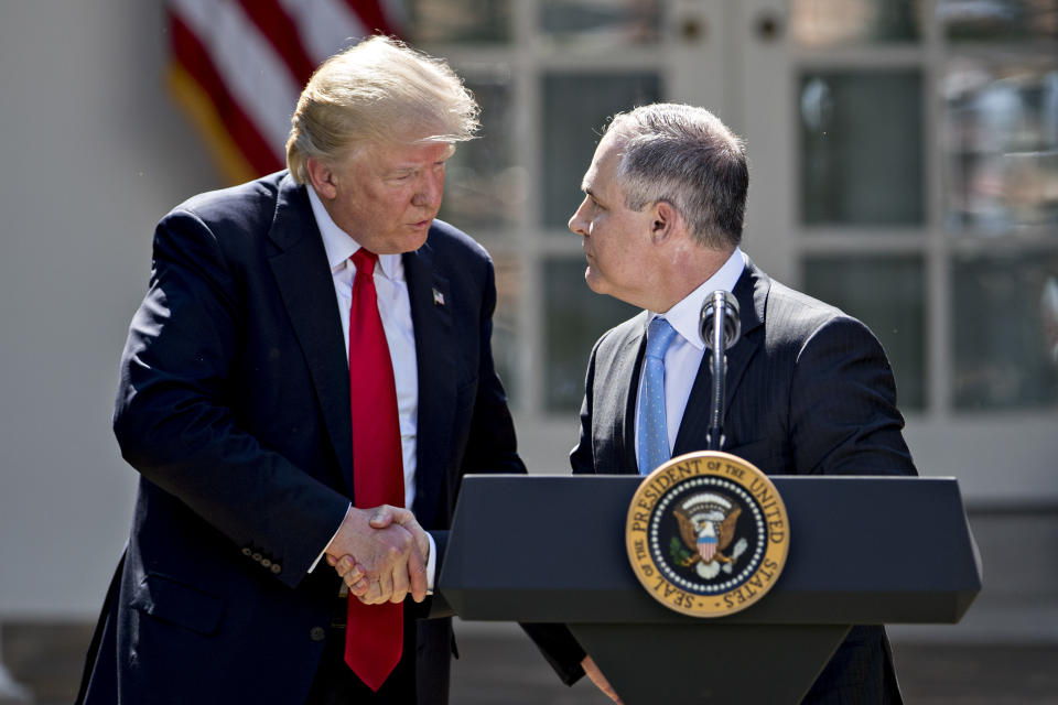 Scott Pruitt, administrator of the Environmental Protection Agency (EPA), right, shakes hands with U.S. President Donald Trump during an announcement in the Rose Garden of the White House in Washington, D.C.in 2017. (Andrew Harrer/Bloomberg via Getty Images)