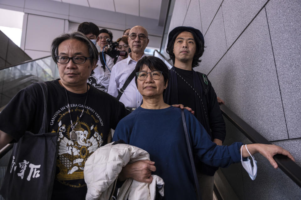 Elizabeth Tang, center, the former chief executive of the now-disbanded pro-democracy group Hong Kong Confederation of Trade Unions (HKCTU), walks out of the police station along with former Chairperson Joe Wong, left, and former vice-chairperson Leo Tang, right, in Hong Kong, on Saturday, March 11, 2023. Tang, who was arrested for endangering national security earlier this week, was released on bail on Saturday. (AP Photo/Louise Delmotte)