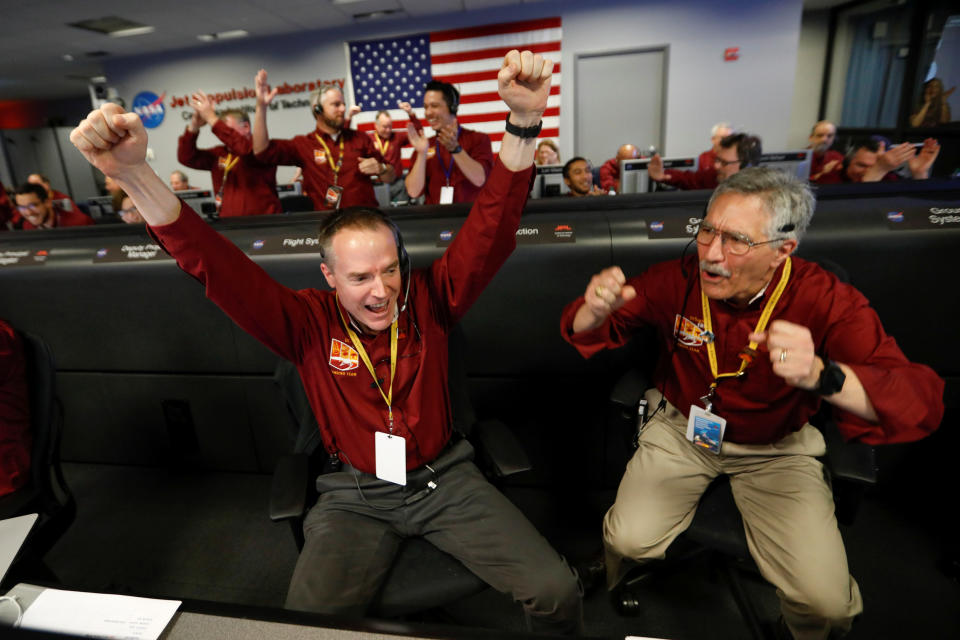 NASA engineers Kris Bruvold (L) and Sandy Krasner celebrate at the operation facility at NASA's Jet Propulsion Laboratory (JPL) after the first picture arrives from the spaceship InSight after it landed on Mars.