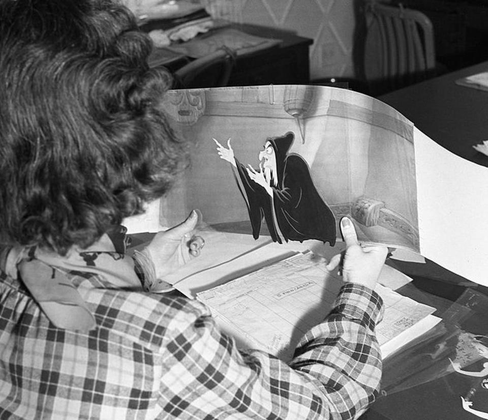 <span class="caption">A Disney animator works on cells from the film ‘Snow White and the Seven Dwarfs.’</span> <span class="attribution"><a class="link " href="https://www.gettyimages.com/detail/news-photo/disney-animator-works-on-cells-from-the-film-snow-white-news-photo/164231016?adppopup=true" rel="nofollow noopener" target="_blank" data-ylk="slk:Earl Theisen/Getty Images;elm:context_link;itc:0;sec:content-canvas">Earl Theisen/Getty Images</a></span>