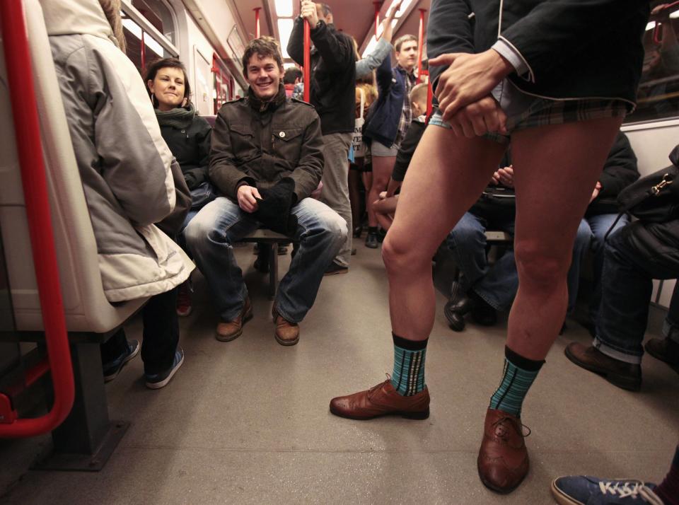 A passenger, not wearing pants, stands in a subway train during the "No Pants Subway Ride" in Prague