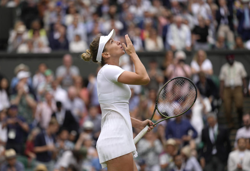 Romania's Simona Halep reacts after beating Amanda Anisimova of the US in a women's singles quarterfinal match on day ten of the Wimbledon tennis championships in London, Wednesday, July 6, 2022. (AP Photo/Kirsty Wigglesworth)