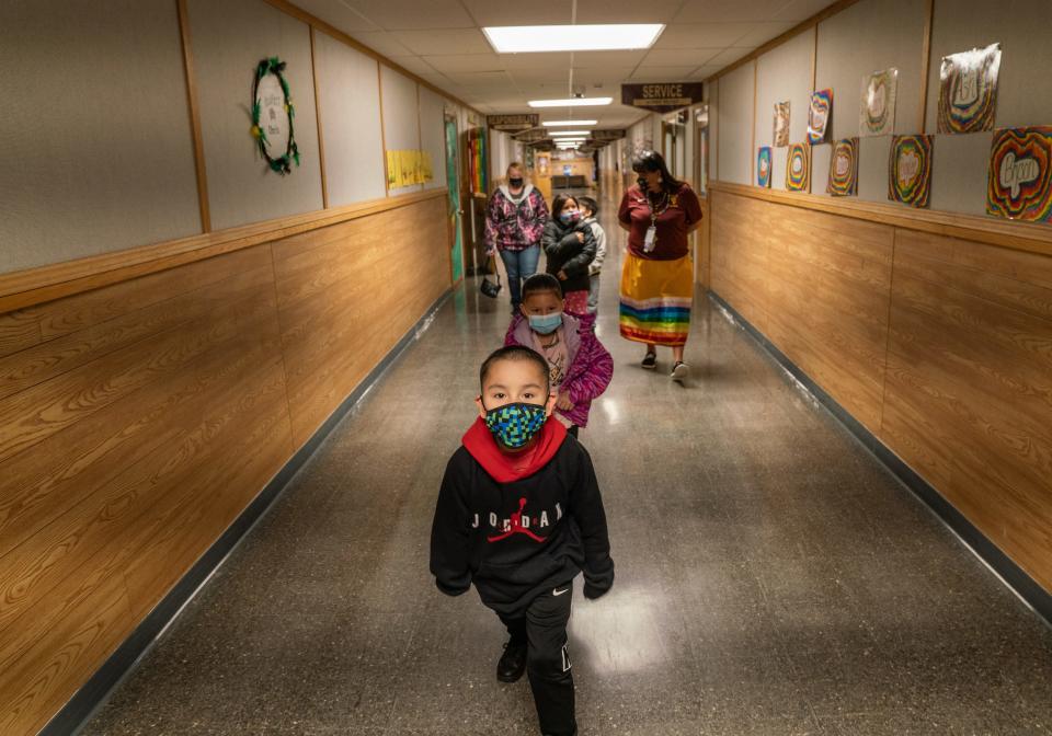 Teacher Shari Daniels, right, walks with her kindergarten class at Poplar Elementary School in mid-March. Daniels attended the school herself as a kid growing up on the neighboring Fort Peck Reservation.
