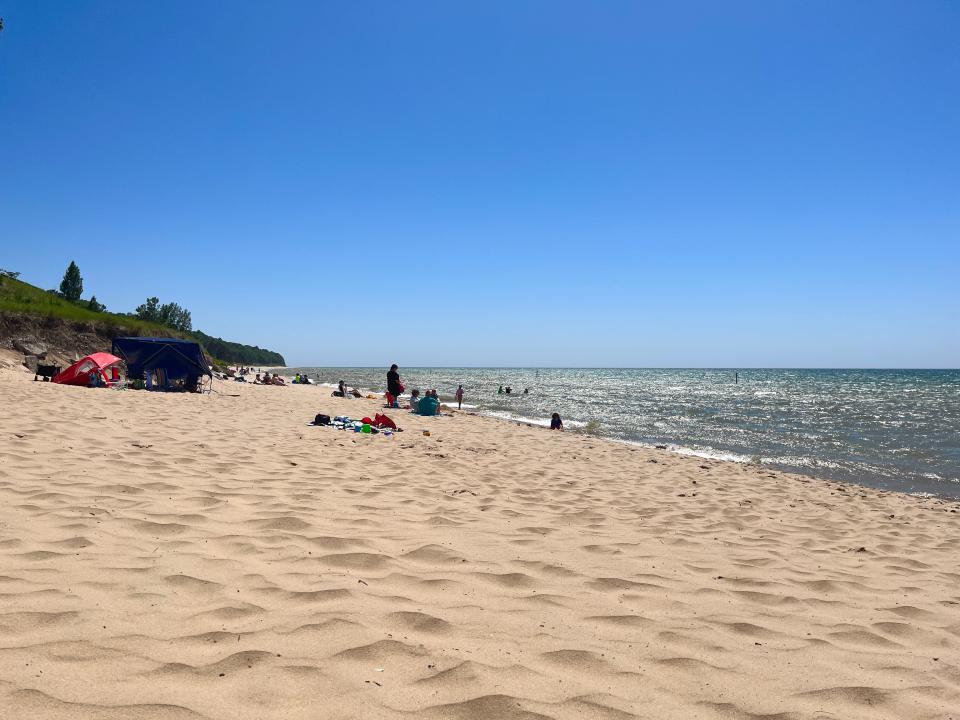 The sand and water under a blue sky at Oval Beach on Lake Michigan