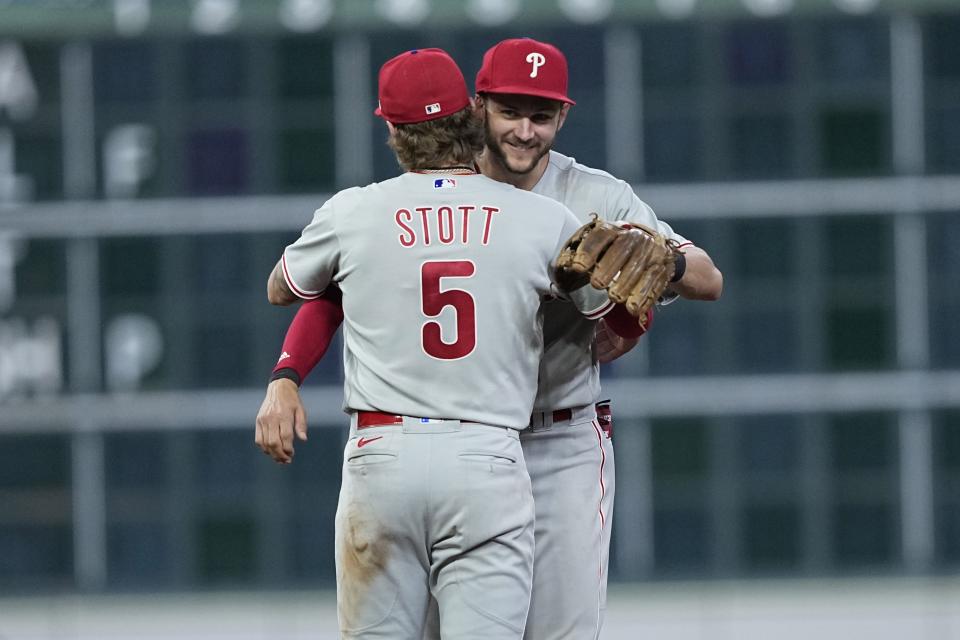 FILE - Philadelphia Phillies' Bryson Stott (5) and Trea Turner celebrate after a baseball game against the Houston Astros Friday, April 28, 2023, in Houston. Turner's speed and instincts helped him set a major league record for most steals in a season without getting caught, going 30-for-30 on the basepaths last year. Stott swiped 31 bags in 34 tries last season. (AP Photo/David J. Phillip, FIle)