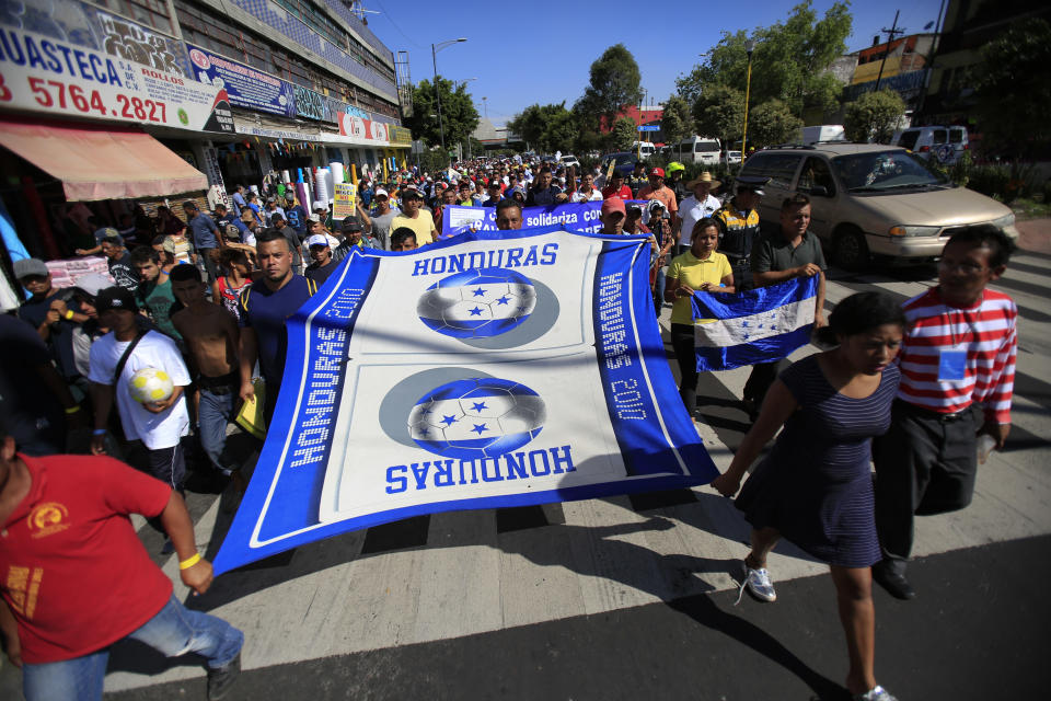 Scores of Central American migrants, representing the thousands participating in a caravan trying to reach the U.S. border, undertake an hours-long march to the office of the United Nations' humans rights body in Mexico City, Thursday, Nov. 8, 2018. Members of the caravan which has stopped in Mexico City demanded buses Thursday to take them to the U.S. border, saying it is too cold and dangerous to continue walking and hitchhiking.(AP Photo/Rebecca Blackwell)