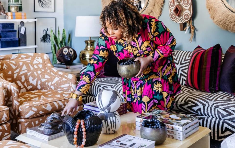 Ariene Bethea, owner and “chief huntress” with Dressing Rooms Interiors Studio in Charlotte, suggests evoking fall with fur throws and branches in vases.