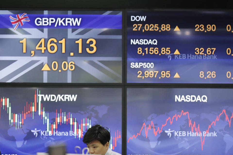 A currency trader watches computer monitors at the foreign exchange dealing room in Seoul, South Korea, Friday, Oct. 18, 2019. Share prices retreated in Asia after China reported Friday that its economy grew at an annual rate of 6.0% in the latest quarter. (AP Photo/Lee Jin-man)