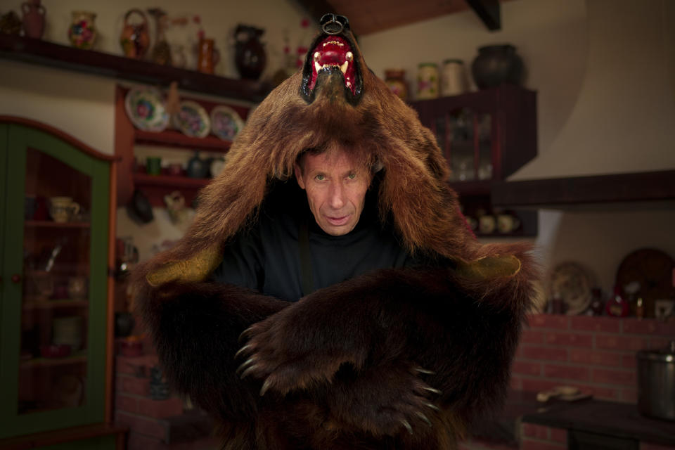 Mitica, 56 years-old, a member of the Sipoteni bear pack, poses for a portrait in Comanesti, northern Romania, Wednesday, Dec. 27, 2023. Mitica first wore the bear fur costume when he was 6 years-old and says he cannot imagine a greater pleasure than dancing in a bear pack during the holiday season. (AP Photo/Andreea Alexandru)