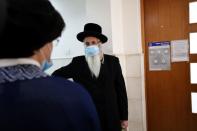 An ultra-Orthodox Jewish man, a family member of Malka Leifer, a former Australian school principal accused of sexually assaulting students, stands outside the courtroom as a verdict is heard in her extradition case at Jerusalem's District Court