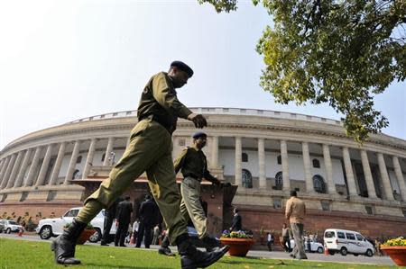 Policemen walk inside the premises of parliament in New Delhi February 13, 2014. REUTERS/Adnan Abidi