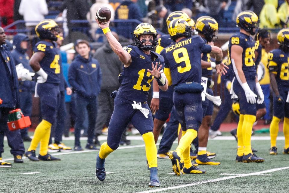 Michigan quarterback Jack Tuttle (13) warms up before the Indiana game at Michigan Stadium in Ann Arbor on Saturday, Oct. 14, 2023.