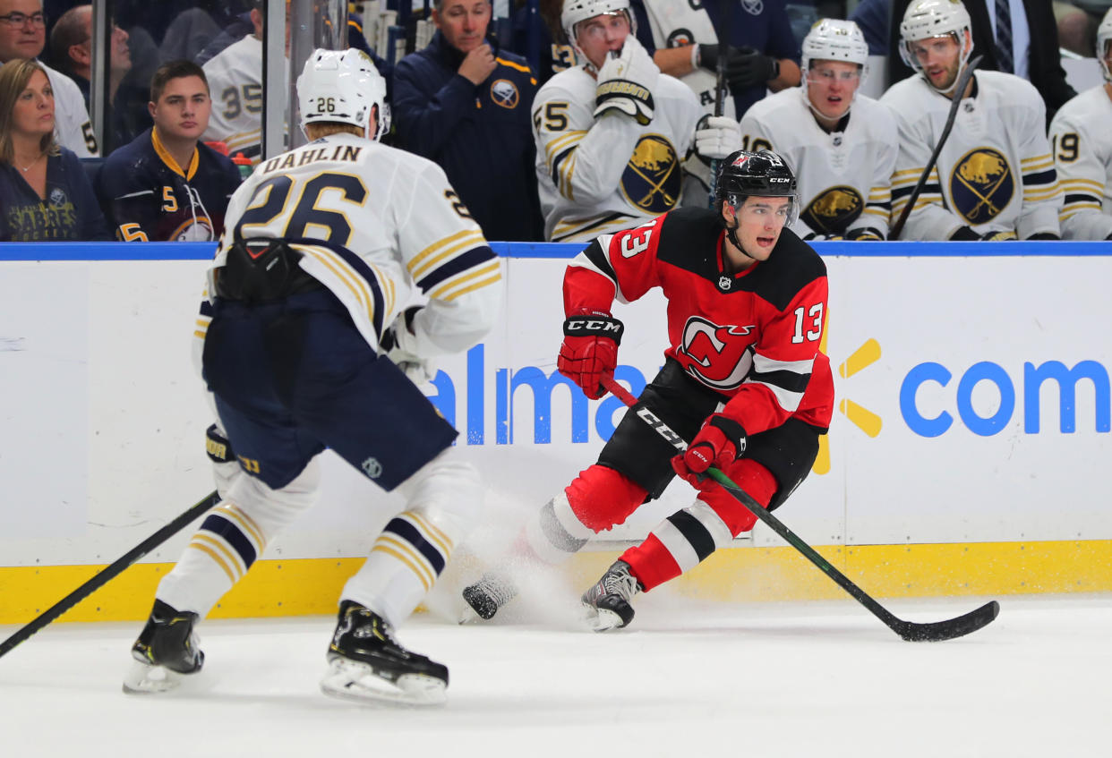 Oct 5, 2019; Buffalo, NY, USA; Buffalo Sabres defenseman Rasmus Dahlin (26) watches as New Jersey Devils center Nico Hischier (13) looks to make a pass during the third period at KeyBank Center. Mandatory Credit: Timothy T. Ludwig-USA TODAY Sports