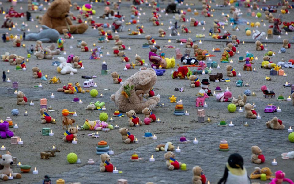 Teddy bears and toys, representing children abducted following the war in Ukraine, are seen on the ground during an event organised by Avaaz NGO and Ukranian refugees at the Rond-point Schuman in Brussels - AFP