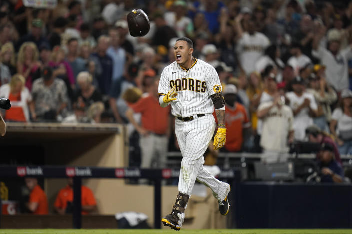 San Diego Padres' Manny Machado tosses his helmet while nearing home after hitting a game-ending, three-run home run against the San Francisco Giants during the ninth inning of a baseball game Tuesday, Aug. 9, 2022, in San Diego. (AP Photo/Gregory Bull)