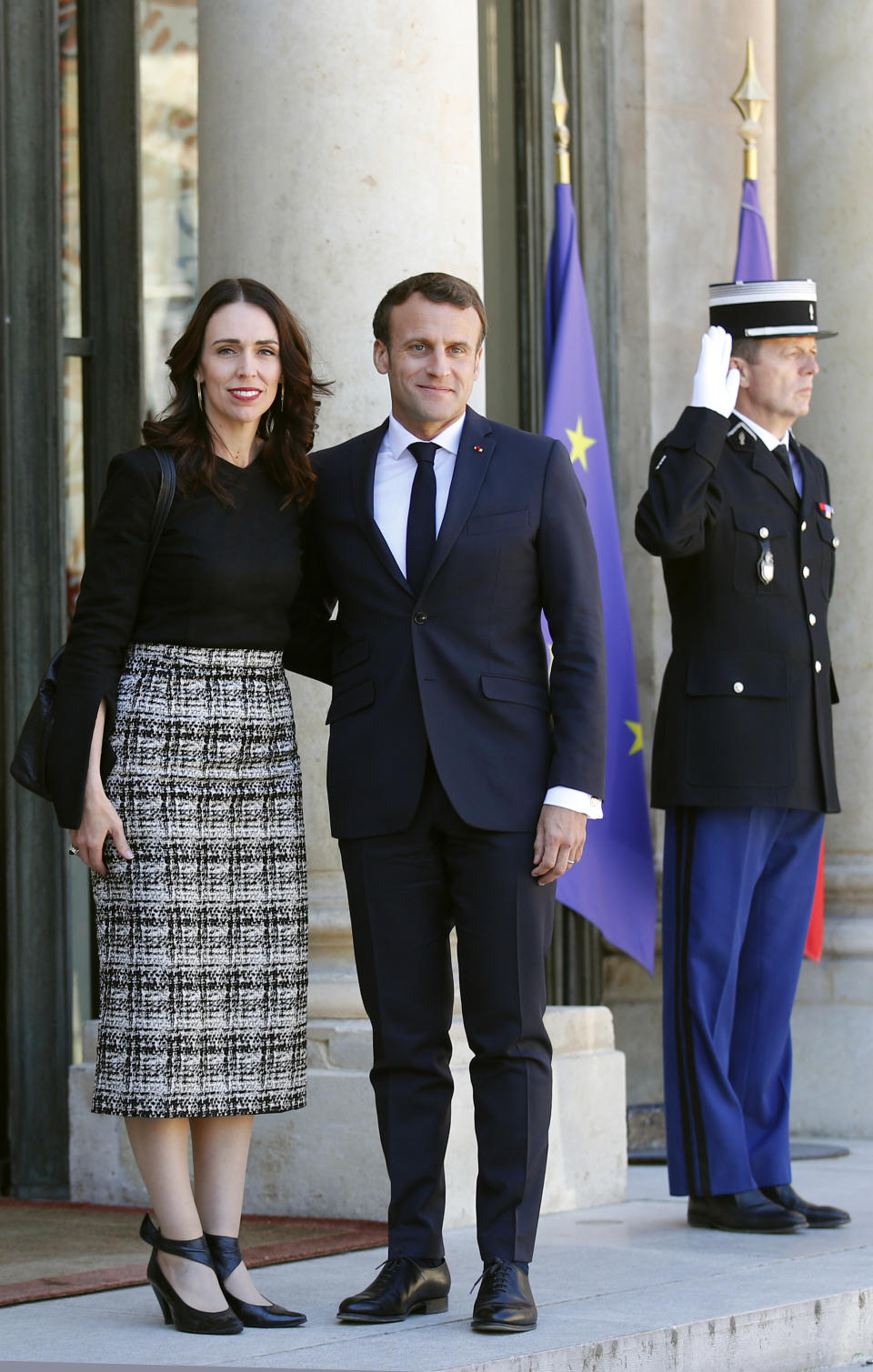 New Zealand Prime Minister Jacinda Ardern, left, is greeted by French President Emmanuel Macron, center, as she arrives at the Elysee Palace, in Paris, Wednesday, May 15, 2019. World leaders and tech bosses meet Wednesday in Paris to discuss ways to prevent social media from spreading deadly ideas. (AP Photo/Francois Mori)