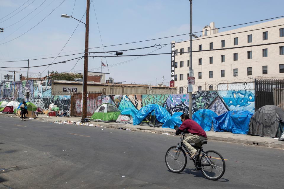 Homeless people and their tents line a Skid Row street in downtown Los Angeles in May.