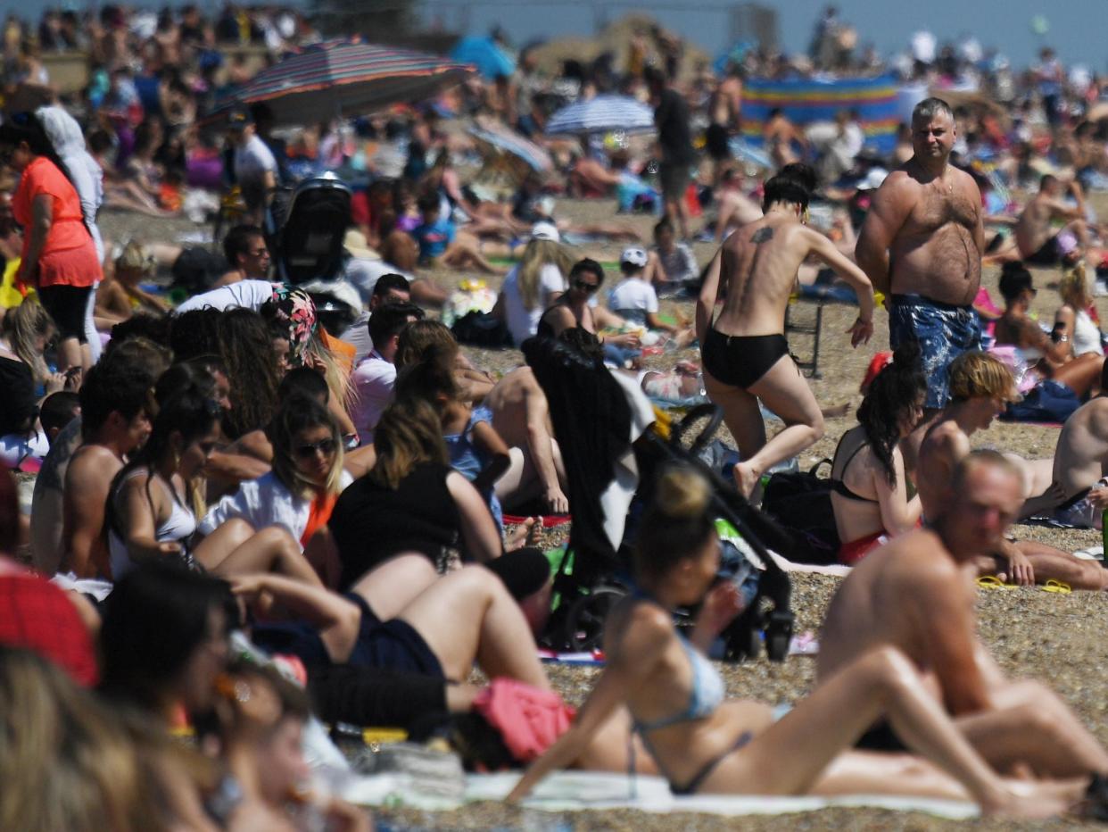 People enjoy the sunshine on the beach at Southend-On-Sea in Essex on Saturday: EPA/NEIL HALL