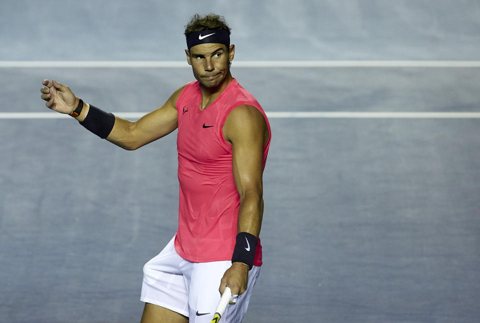 Rafael Nadal frowns on a tennis court.