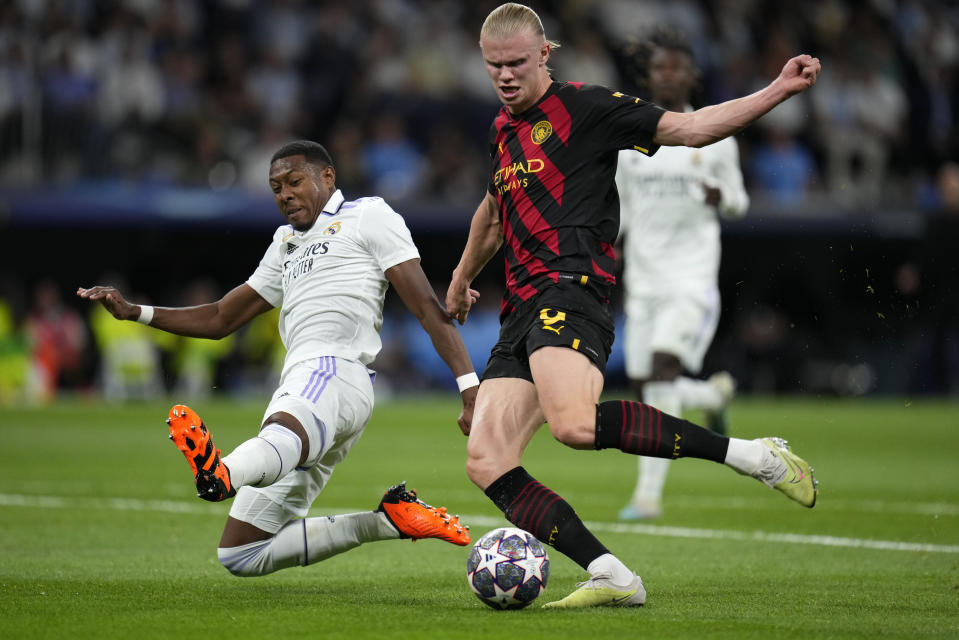 Real Madrid's David Alaba slides in to block a shot by Manchester City's Erling Haaland during the Champions League semifinal first leg soccer match between Real Madrid and Manchester City at the Santiago Bernabeu stadium in Madrid, Spain, Tuesday, May 9, 2023. (AP Photo/Manu Fernandez)