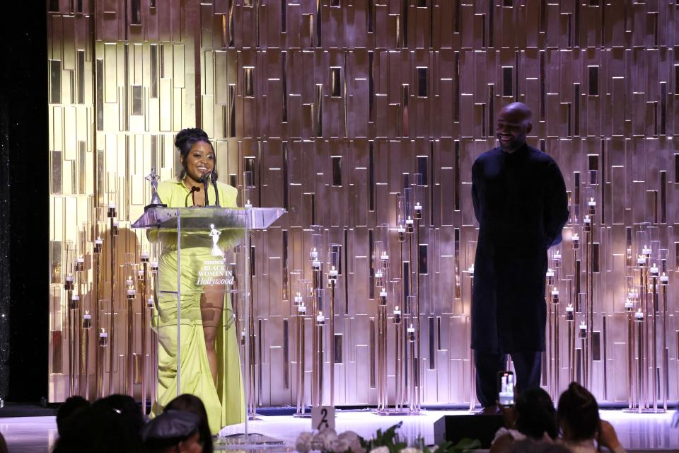 Honoree Quinta Brunson (L) accepts an award onstage from Donald Glover during the 2022 15th annual Essence Black Women In Hollywood Awards.