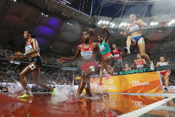 <span class="article__caption">BUDAPEST, HUNGARY – AUGUST 23: Beatrice Chepkoech of Team Kenya, Winfred Mutile Yavi of Team Bahrain and Courtney Wayment of Team United States compete in the Women’s 3000m Steeplechase Heats during day five of the World Athletics Championships Budapest 2023 at National Athletics Centre on August 23, 2023 in Budapest, Hungary. (Photo by Steph Chambers/Getty Images)</span>