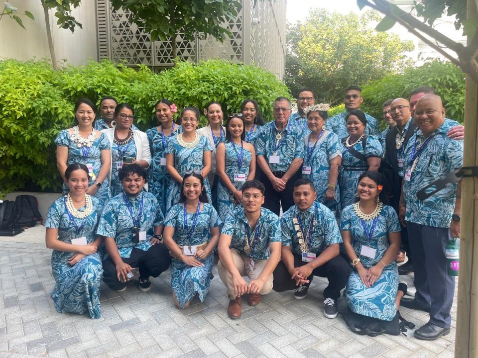 Some of Marshall Islands delegation take a group picture in coordinating outfits after launching their National Adaptation Plan at Cop28 (Louise Boyle/The Independent)
