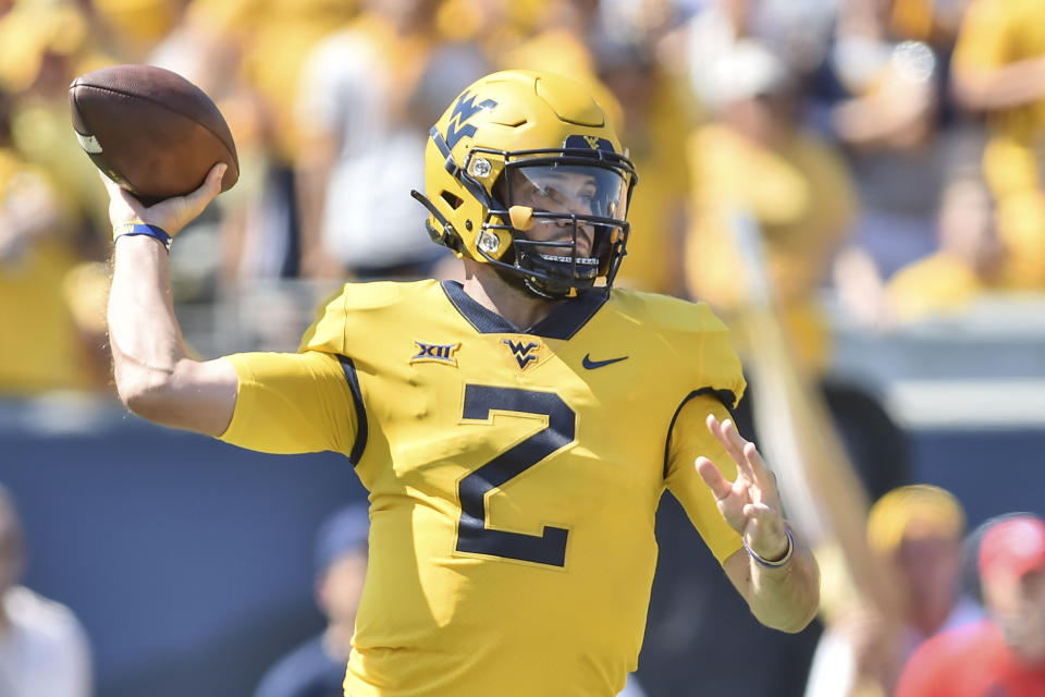 West Virginia quarterback Jarret Doege (2) makes a pass against Virginia Tech during the first half of an NCAA college football game in Morgantown, W.Va., Saturday, Sep. 18, 2021. (AP Photo/William Wotring)