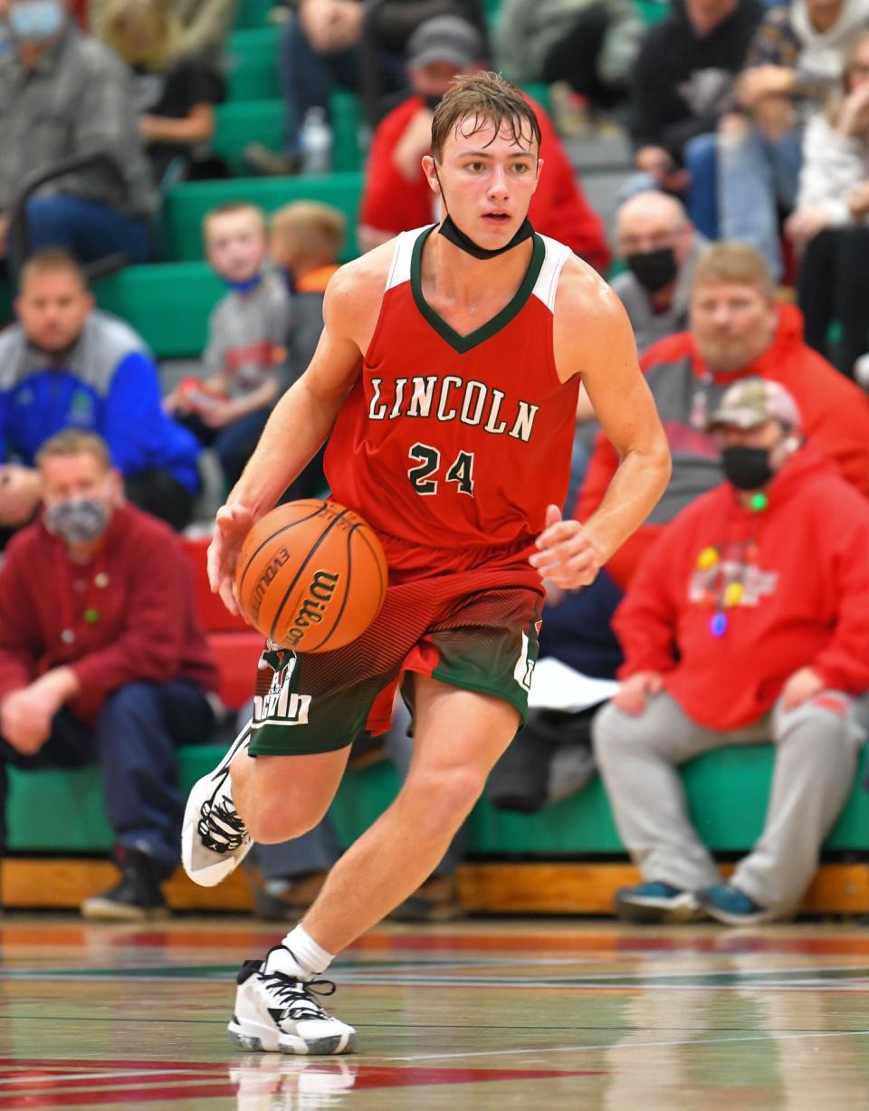 Lincoln's Jake Bivin brings the ball up the court against Danville on Nov. 24.