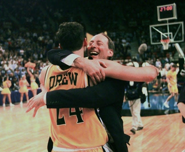 Valparaiso coach Homer Drew hugs his son, Bryce Drew, after Bryce hit a game-winning 3-pointer at the buzzer to beat Mississippi 70-69 in the first round of the NCAA Midwest Regional in Oklahoma City. [AP Photo/John Gaps III, File]