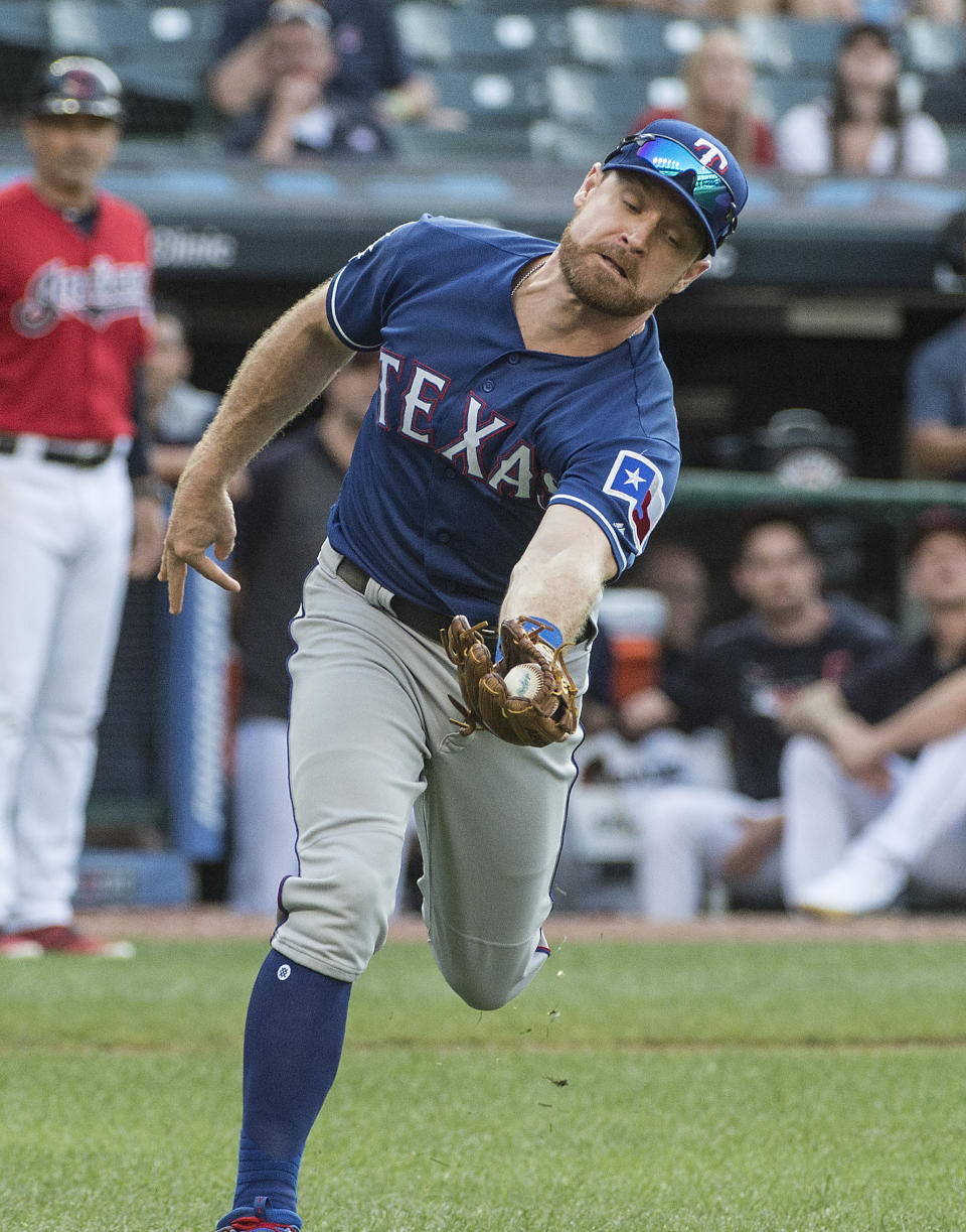 Texas Rangers' Logan Forsythe catches a pop fly by Cleveland Indians' Tyler Naquin during the seventh inning of the second game of a baseball doubleheader in Cleveland, Wednesday, Aug. 7, 2019. (AP Photo/Phil Long)
