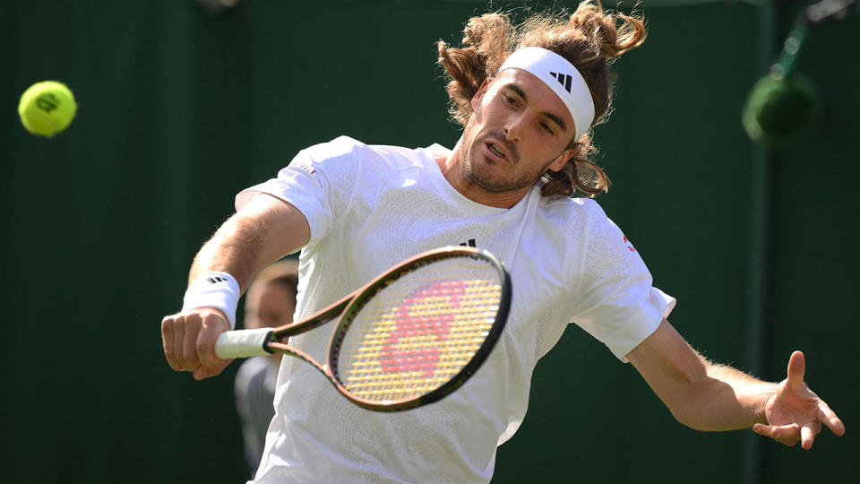 Seen here, Stefanos Tsitsipas plays a backhand in his first round win over Dominic Thiem at Wimbledon. 
