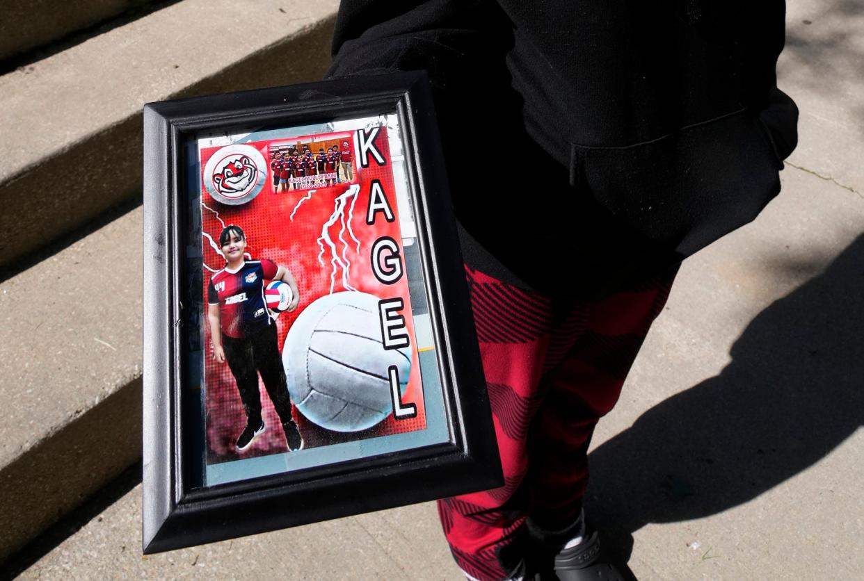 Brandy Ortiz, 14, holds a photo of her sister, 10-year-old Isdennyeliz Ortiz, with her volleyball team, who was shot and killed on the 2100 block of West Orchard Street in Milwaukee on May 31.