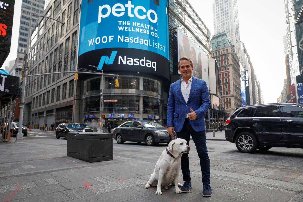 Ron Coughlin, CEO of Petco Health and Wellness Company, Inc., poses with his dog Yummy during the company's IPO at the Nasdaq Market Site in Times Square in New York City, U.S., January 14, 2021.  REUTERS/Brendan McDermid