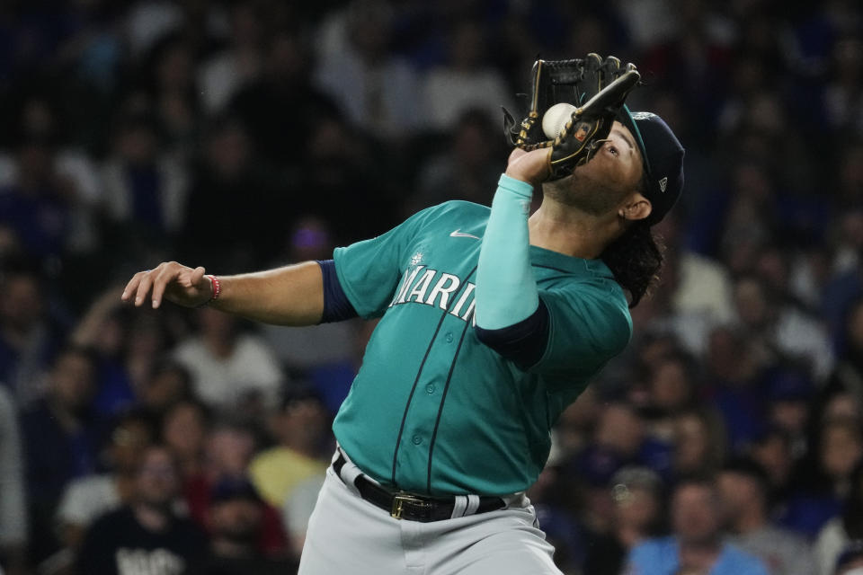 Seattle Mariners third baseman Eugenio Suarez catches a fly ball by Chicago Cubs' Cody Bellinger during the fifth inning of a baseball game in Chicago, Tuesday, April 11, 2023. (AP Photo/Nam Y. Huh)