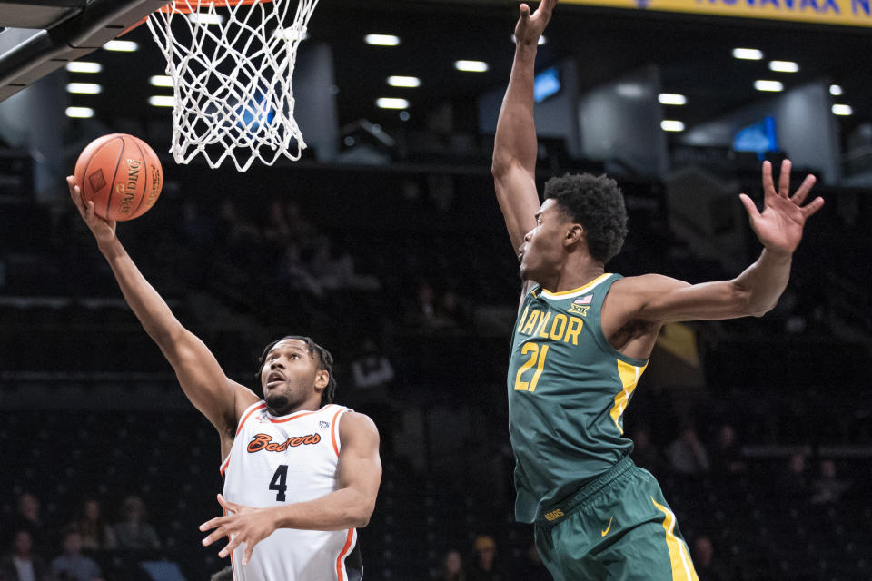 Oregon State guard Dexter Akanno (4) drives to the basket against Baylor center Yves Missi (21) during the first half of an NCAA college basketball game Wednesday, Nov. 22, 2023, in New York. (AP Photo/Eduardo Munoz Alvarez)