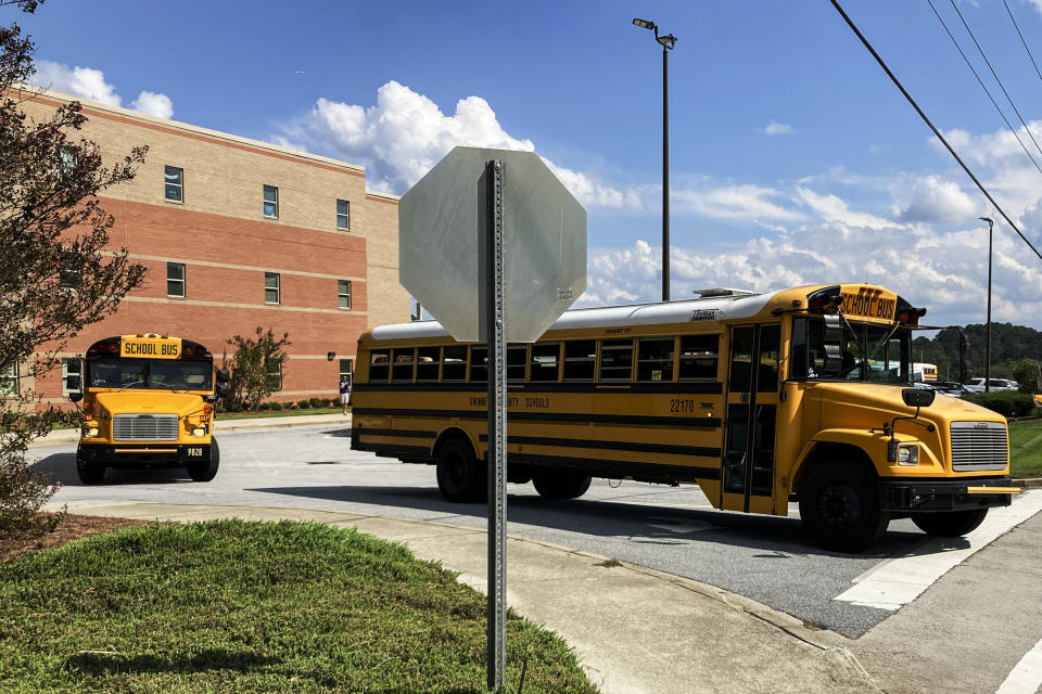 Buses depart from Camp Creek Elementary School in Lilburn, Ga., after school on Monday, Sept. 12, 2022. Polls show K-12 education trailing among voter concerns in Georgia this year as candidates talk more about inflation, the economy, abortion and guns. (AP Photo/Jeff Amy)