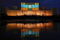 A Euro 2020 themed video mapping is projected on the facade of the communist era built Palace of Parliament, formerly known as the House of the People, in Bucharest, Romania, Friday, June 11, 2021, two days before the city hosts its first game between Austria and North Macedonia. (AP Photo/Vadim Ghirda)