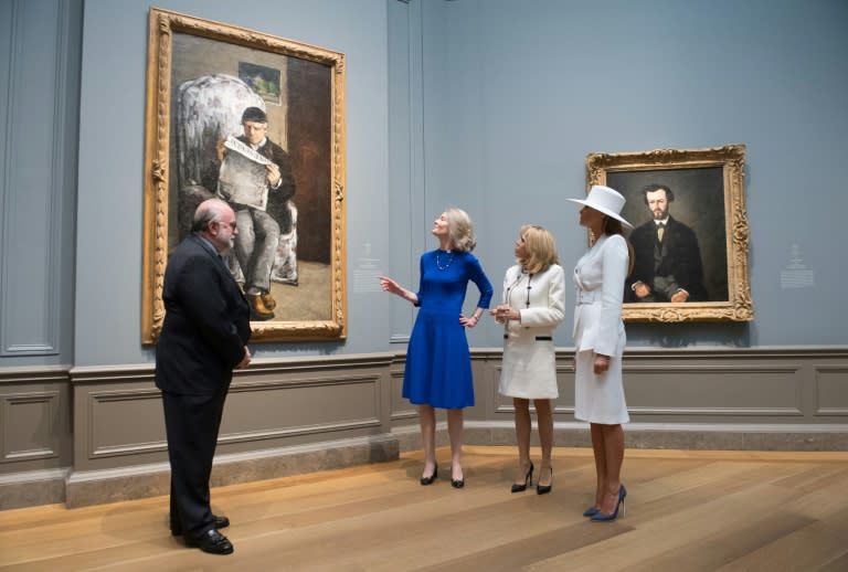 Mary Morton (2nd-L), head of the department of French paintings, speaks with US First Lady Melania Trump (R) and French First Lady Brigitte Macron, alongside senior curator Franklin Kelly at the National Gallery of Art's Paul Cezanne portraits show