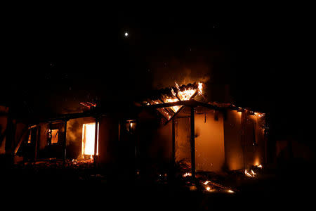 A house burns as a wildfire rages at the village of Mati, near Athens, Greece, July 23, 2018. REUTERS/Alkis Konstantinidis