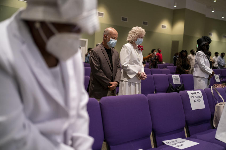 People wear face masks at the New Horizon International Church, Sunday, Oct. 4, 2020, in Jackson, Miss. In the wake of the coronavirus pandemic, there are carefully enforced mask mandates, multiple disinfectant stations, parishioners who sit 2 or 3 pews apart, cameras to broadcast sermons to people who want to stay at home and pastors who don't let anyone forget the disease is serious. (AP Photo/Wong Maye-E)