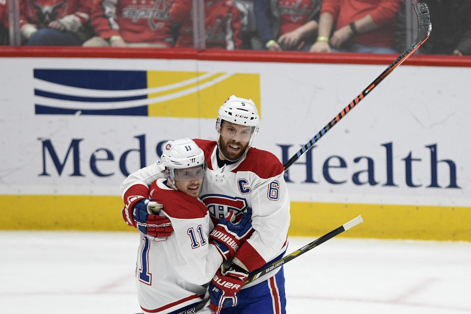Montreal Canadiens right wing Brendan Gallagher (11) celebrates his goal with defenseman Shea Weber (6) during the second period of an NHL hockey game against the Washington Capitals, Thursday, Feb. 20, 2020, in Washington. (AP Photo/Nick Wass)