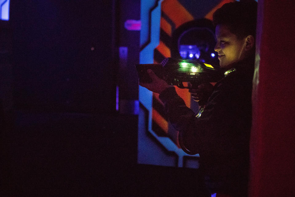 A young man has his laser gun during a game of laser tag at Main Event in Newark.