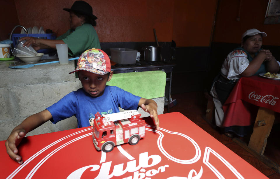 A child plays with a fire engine at a restaurant that reopened for business as Ecuadorians returned to a semblance of normality after nearly two weeks of protests, in Quito Ecuador, Monday, Oct. 14, 2019. Protests over an austerity package blocked roads, shuttered businesses from dairies to flower farms and halved Ecuador's oil production, forcing a temporary halt to the country's most important export. (AP Photo/Dolores Ochoa)