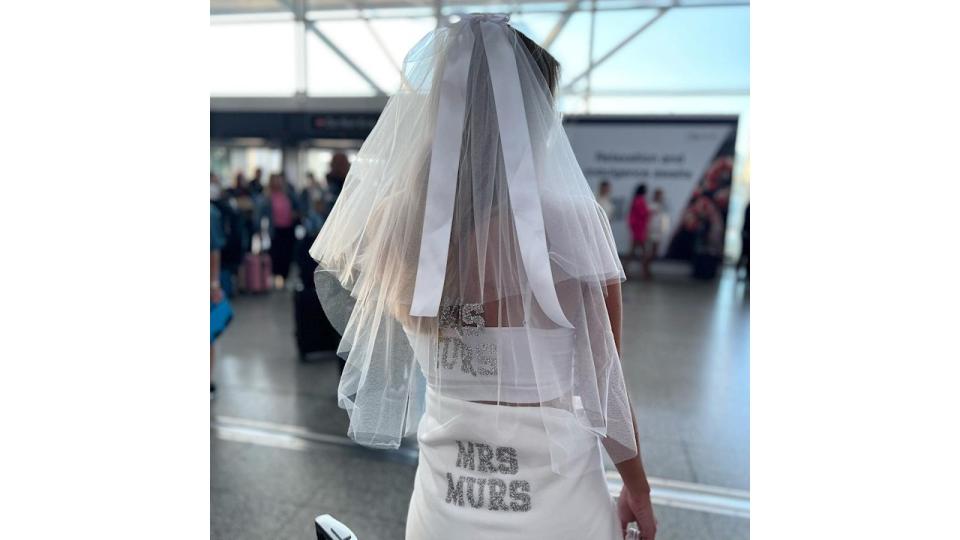 Amelia wearing a personalised veil in airport